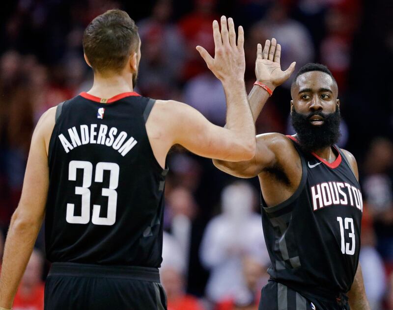 Houston Rockets guard James Harden (13) high-fives Ryan Anderson late in the second half of the team'sp NBA basketball game against the Orlando Magic, Tuesday, Jan. 30, 2018, in Houston. Houston won 114-107. (AP Photo/Eric Christian Smith)
