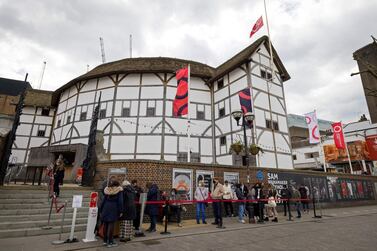 Members of the public, wearing face coverings due to Covid-19, queue for a guided tour of Shakespeare's Globe theatre in London on April 14, 2021. Following the UK's massive vaccine rollout, non-essential retail such as clothes shops, and hospitality including restaurants and pubs, reopened their doors across England on April 12. / AFP / Tolga Akmen
