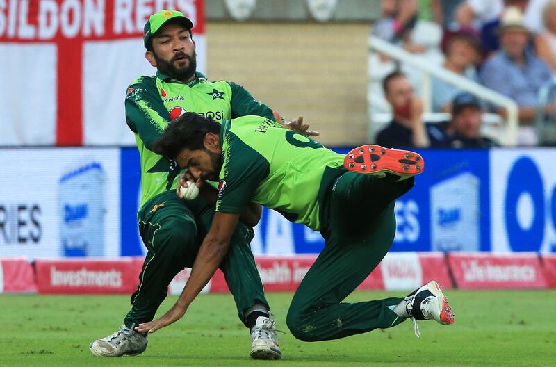 Pakistan's Haris Rauf, right, holds a catch to dismiss England batsman Moeen Ali, despite crashing into teammate Sohaib Maqsood, during the T20 international at Trent Bridge, in Nottingham, England, on Friday, July 16.