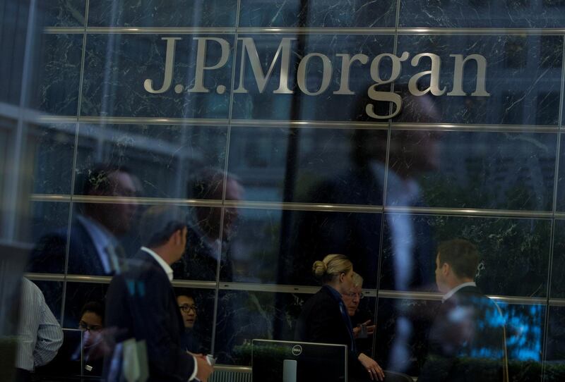FILE PHOTO: Workers are reflected in the windows of the Canary Wharf offices of JP Morgan in London September 19, 2013. REUTERS/Neil Hall/File Photo