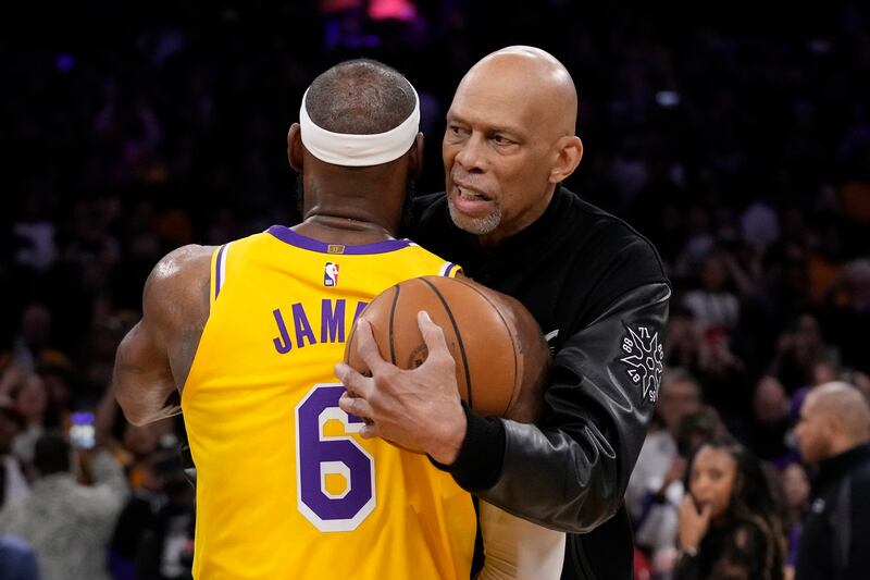 Los Angeles Lakers forward LeBron James, left, is hugged by Kareem Abdul-Jabbar in Los Angeles. AP