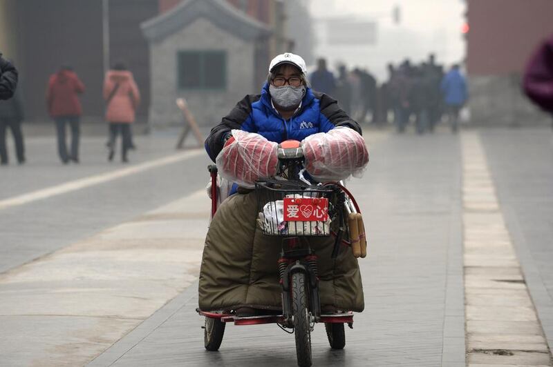 A woman wearing a mask in haze-covered Temple of Heaven in Beijing on February 24. Images of statues of Chinese intellectuals Li Dazhao, Cai Yuanpei and Chen Daisun, along with Spanish writer Miguel de Cervantes, wearing anti-pollution facemasks are currently among the most shared on Chinese social media. “This is a silent protest!”, said one netizen on Sina Weibo, China’s version of Twitter, under a picture of the statues at Peking University.  China Out/AFP Photo

