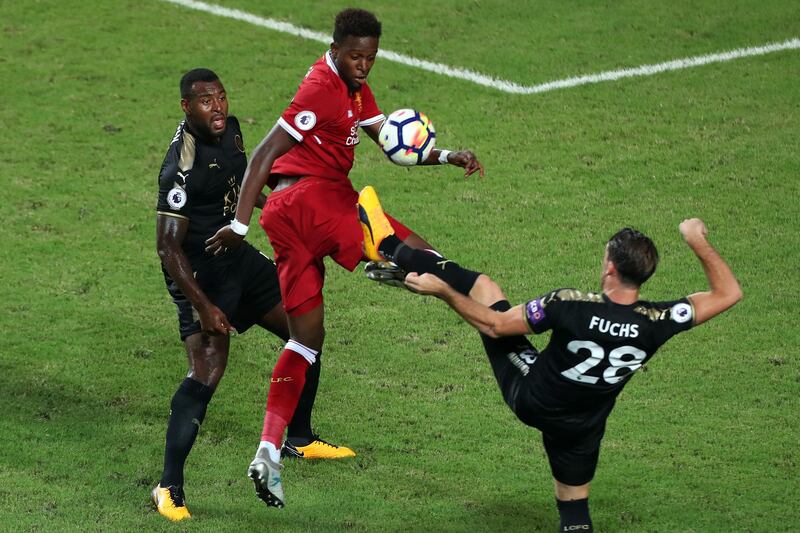 Liverpool's Divock Origi battles for the ball. Stanley Chou / Getty Images