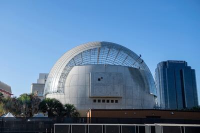 Workers clean the roof of the new Academy Museum of Motion Pictures, amid the coronavirus pandemic, October 14, 2020, in Los Angeles, California. - The museum is set to open in April 2021. (Photo by VALERIE MACON / AFP)