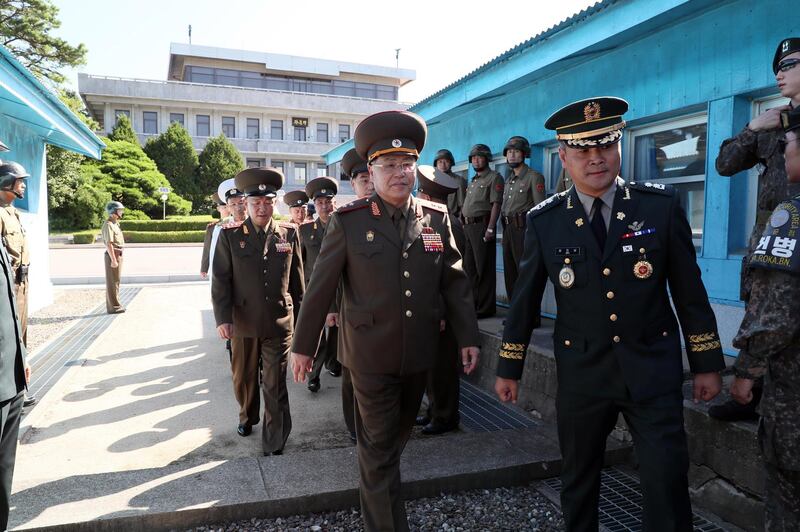 A handout photo made available by the South Korean Ministry of National Defense shows North Korean Lt. Gen. An Ik-san (L) crossing to southern side for the meeting with South Korea's chief delegate Major Gen. Kim Do-gyun (not pictured) near the Peace House on the southern side of the border truce village Panmunjom in Paju, South Korea, 31 July 2018.  EPA / MINISTRY OF NATIONAL DEFENSE