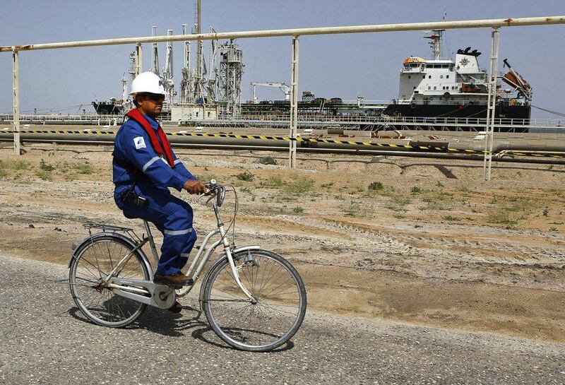 Qatar has invited all 13 members of Opec and major non-Opec producers to Doha on April 17 for another round of talks. pictured, an Iraqi engineer cycles past a tanker in Basra. AP Photo