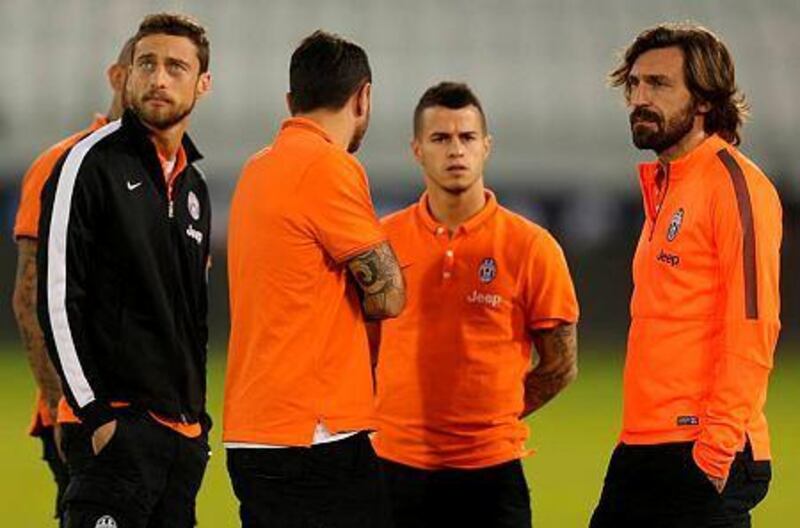 Juventus players arrive for a training session in Doha on December 21, 2014, on the eve of the Italian Super Cup final football match between Juventus and Napoli. AFP PHOTO / AL-WATAN DOHA / KARIM JAAFAR