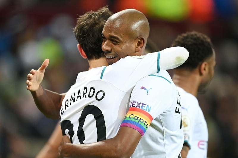 Fernandinho of Manchester City congratulates teammate Bernardo Silva. Getty