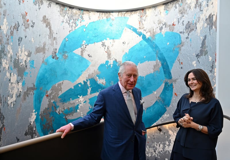Speaking with Iranian artist Shahrzad Ghaffari in front of her mural artwork, called Oneness, 2022. Getty Images