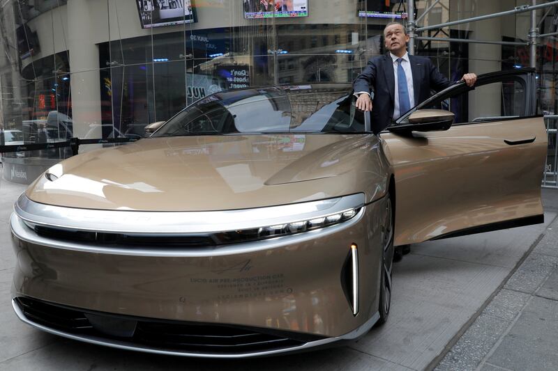 Lucid Motors' chief executive and chief technology officer Peter Rawlinson poses with a Lucid Air after ringing the opening bell at Nasdaq last year. Reuters
