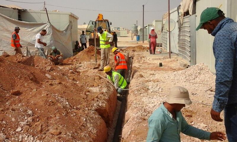 Labourers carry out work on a project funded by the UAE to improve water, sanitation and hygiene for Syrian refugees in the Zaatari camp in Jordan. Courtesy UNCHR 