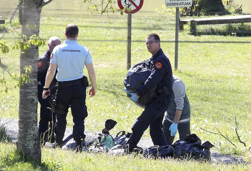 French police officers collect plastic bags at a hideout used by Basque separatist guerrillas ETA in Saint Pee sur Nivelle in south-western France on April 8, 2017. Bob Edme / AP Photo