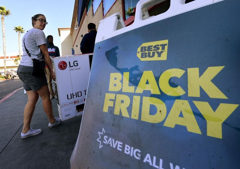 Shoppers with their arms full walk to their cars during the Black Friday sales at a store in California. Mark Ralston / AFP