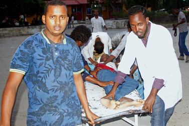 Medical workers help a civilian on stretcher who was wounded in suicide bomb, at Madina hospital, Mogadishu. AP