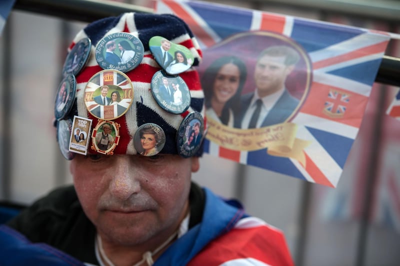 A royal fan waits along the proposed route of the carriage procession for Britain's Prince Harry and US actress Meghan Markle. Oli Scarff / AFP Photo