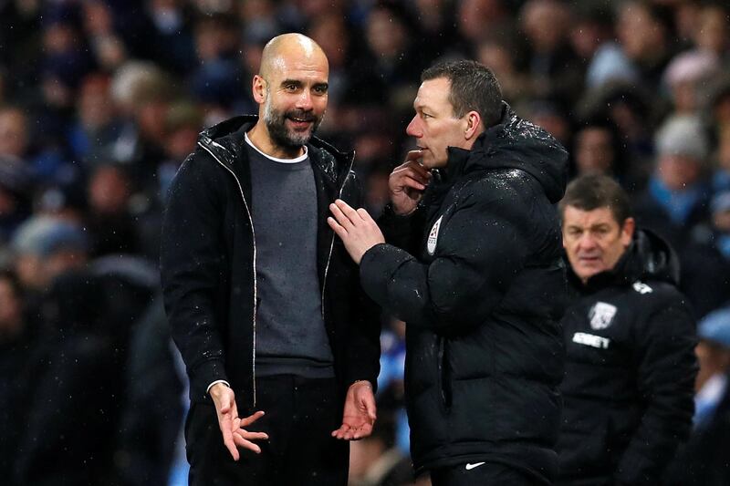 Soccer Football - Premier League - Manchester City vs West Bromwich Albion - Etihad Stadium, Manchester, Britain - January 31, 2018   Manchester City manager Pep Guardiola talks to fourth official Kevin Friend     Action Images via Reuters/Jason Cairnduff    EDITORIAL USE ONLY. No use with unauthorized audio, video, data, fixture lists, club/league logos or "live" services. Online in-match use limited to 75 images, no video emulation. No use in betting, games or single club/league/player publications.  Please contact your account representative for further details.