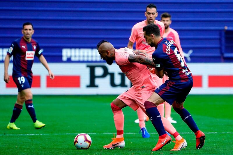 Eibar's Gonzalo Escalante, right, challenges Barcelona's Arturo Vidal. AFP