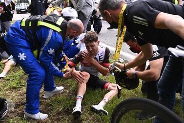 Team UAE Emirates' Marc Hirschi of Switzerland receives medical treatment after crashing during the 1st stage of the 108th edition of the Tour de France cycling race, 197 km between Brest and Landerneau, on June 26, 2021. / AFP / POOL / Anne-Christine POUJOULAT