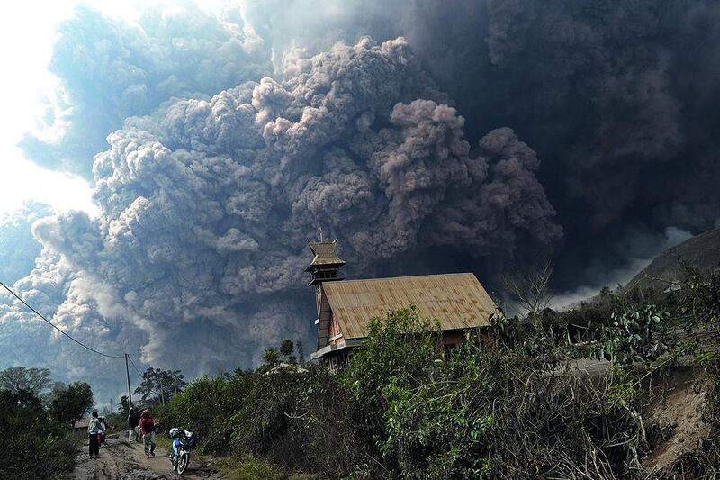 A giant cloud of hot volcanic ash clouds engulfs villages in Karo district during the eruption of Mount Sinabung volcano located on Indonesia’s Sumatra island on February 1. Fourteen people, including four schoolchildren, were killed February 1 after they were engulfed by scorching ash clouds. Sutanta Aditya / AFP