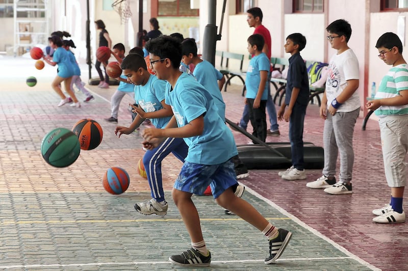 DUBAI , UNITED ARAB EMIRATES , JULY 4 – 2018 :- Students from grade 3 to 8 taking part in the basketball summer camp held at Indian High School in Garhoud area in Dubai.  ( Pawan Singh / The National )  For News. Story by Anam Rizvi
