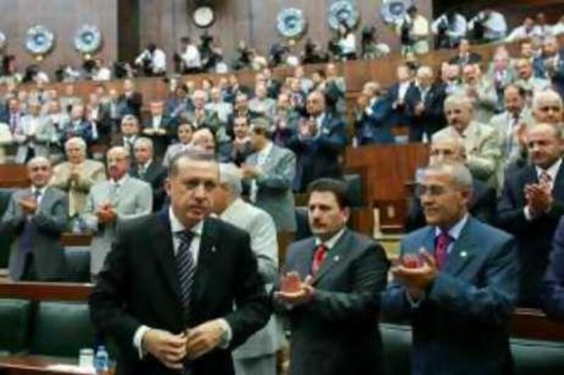 Turkey's Prime Minister Tayyip Erdogan leaves his seat to address his ruling AK Party (AKP) MPs during a meeting at the Turkish parliament in Ankara July 29, 2008. Erdogan called for unity in Turkey on Monday after 17 people were killed in two bombings in Istanbul and said a court case to close his ruling party was not currently a priority. REUTERS/Umit Bektas (TURKEY) *** Local Caption ***  ANK02_TURKEY-ERDOGA_0729_11.JPG