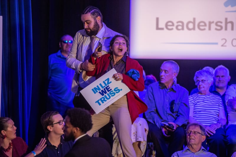 A protester is removed as Ms Truss speaks during the Conservative Party leadership hustings in Eastbourne. Bloomberg