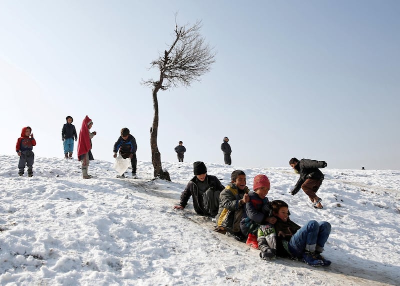Afghan boys slide down a snow-covered slope in Kabul, Afghanistan. Mohammad Ismail / Reuters