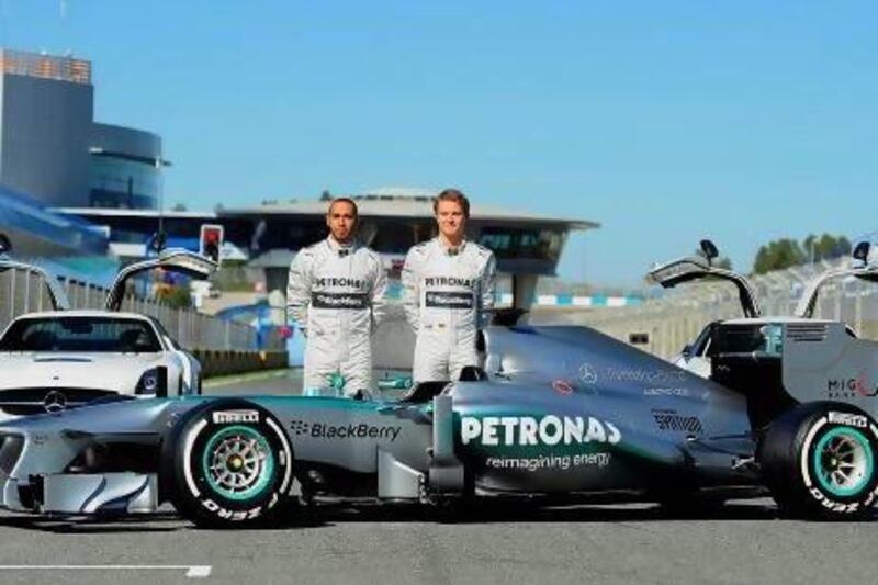 Formula One drivers Nico Rosberg, right, and Lewis Hamilton pose with the new Mercedes W04 as part of the Formula One training session at Jerez racetrack on Monday. Cristina Quicler / AFP Photo