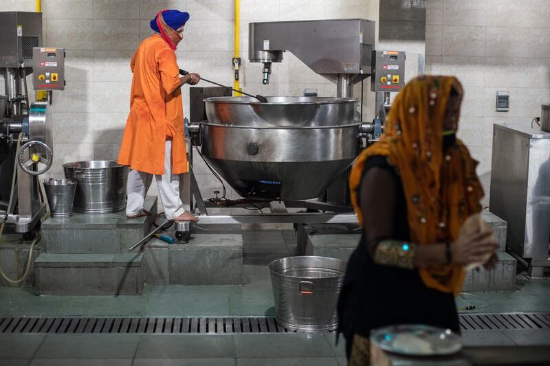 Volunteers prepare meals to be donated to patients across the city suffering from Covid-19, made at the Gurudwara Bangla Sahib, in New Delhi. Getty Images