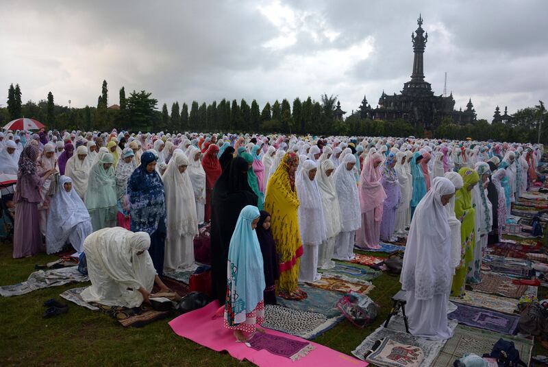 Muslims attend prayers for Eid Al-Fitri near Bajra Sandhi Monument in Denpasar, Bali, Indonesia June 25, 2017 in this photo taken by Antara Foto. Antara Foto/Wira Suryantala/ via REUTERS ATTENTION EDITORS - THIS IMAGE WAS PROVIDED BY A THIRD PARTY. MANDATORY CREDIT. INDONESIA OUT. NO COMMERCIAL OR EDITORIAL SALES IN INDONESIA.