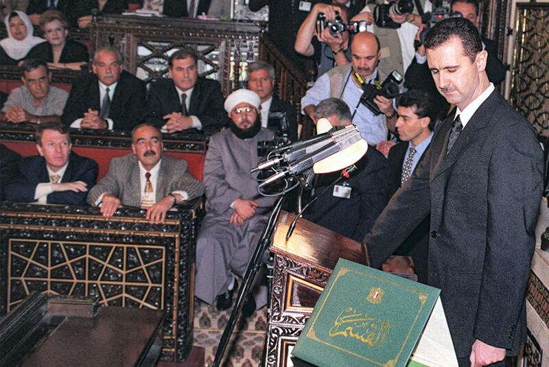 (FILES) In this handout file photo provided by the Syrian Arab News Agency SANA on July 17, 2000, Syria's new President Bashar al-Assad (R) takes the oath of office at the Syrian parliament in the capital Damascus. - President Bashar al-Assad, whose family has ruled Syria for over half a century, faces an election this week meant to cement his image as the only hope for recovery in the war-battered country, analysts say. (Photo by - / SANA / AFP) / == RESTRICTED TO EDITORIAL USE - MANDATORY CREDIT "AFP PHOTO / HO / SANA" - NO MARKETING NO ADVERTISING CAMPAIGNS - DISTRIBUTED AS A SERVICE TO CLIENTS ==