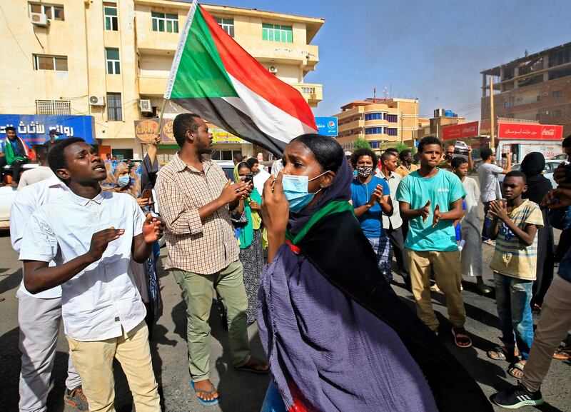 Sudanese protesters, some clad in masks as a precaution due to the coronavirus pandemic, gather to mark the first anniversary of a raid on an anti-government sit-in, in the Riyadh district in the east of the capital Khartoum. AFP