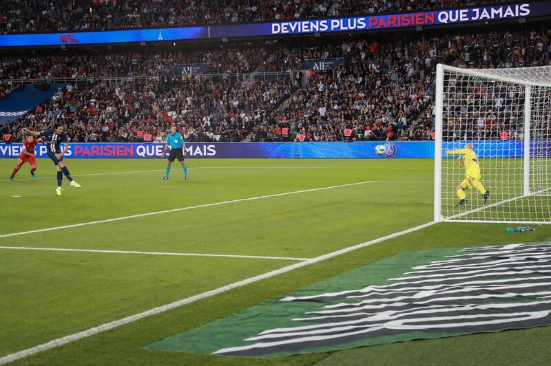 Edinson Cavani dispatches his first half penalty against Nimes. AFP