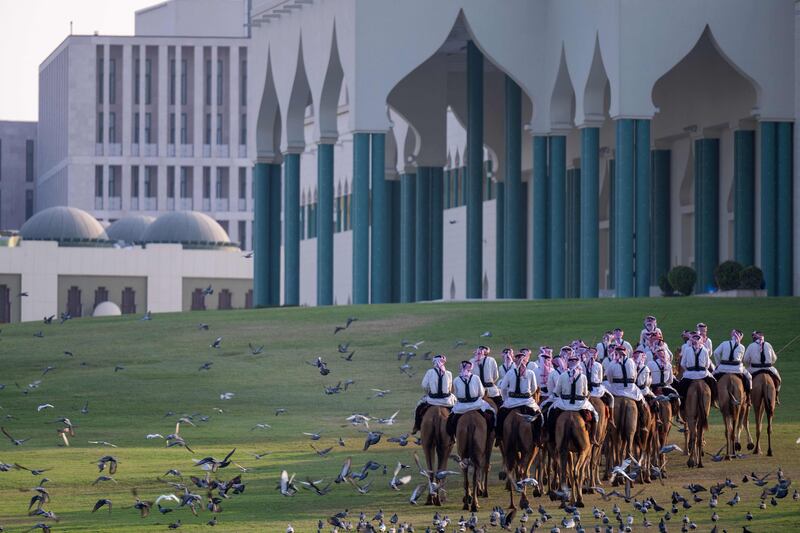 Camel-mounted royal guards patrol the Emiri Diwan in Doha.  AFP