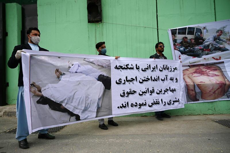 Civil society activists hold banners and shout slogans against the Iranian government during a protest in front of the Iranian embassy in Kabul on May 11, 2020. AFP