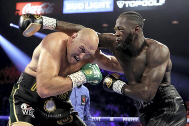 LAS VEGAS, NEVADA - FEBRUARY 22: Deontay Wilder (R) punches Tyson Fury during their Heavyweight bout for Wilder's WBC and Fury's lineal heavyweight title on February 22, 2020 at MGM Grand Garden Arena in Las Vegas, Nevada. Al Bello/Getty Images/AFP