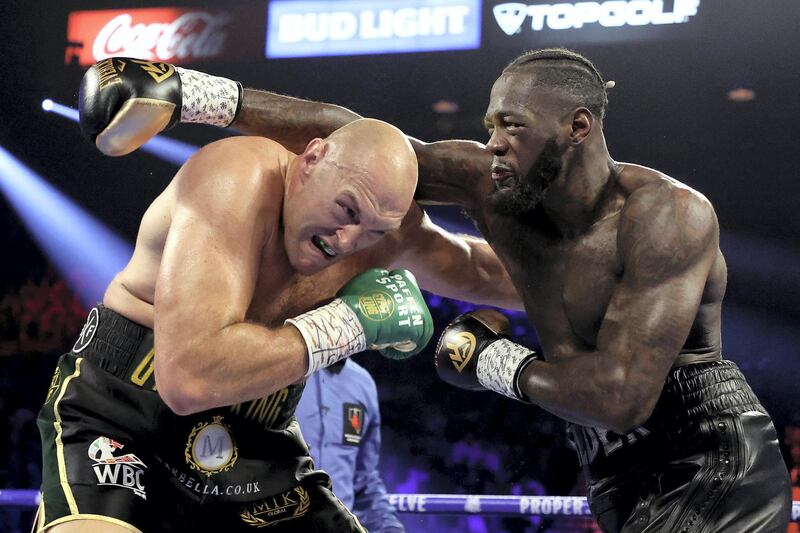 LAS VEGAS, NEVADA - FEBRUARY 22: Deontay Wilder (R) punches Tyson Fury during their Heavyweight bout for Wilder's WBC and Fury's lineal heavyweight title on February 22, 2020 at MGM Grand Garden Arena in Las Vegas, Nevada.   Al Bello/Getty Images/AFP