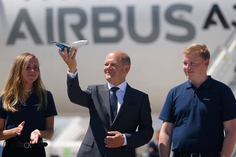 Olaf Scholz receives a model of an Airbus Zero E aircraft from trainees on the first day of the ILA Berlin 2022 air show in June. Getty Images
