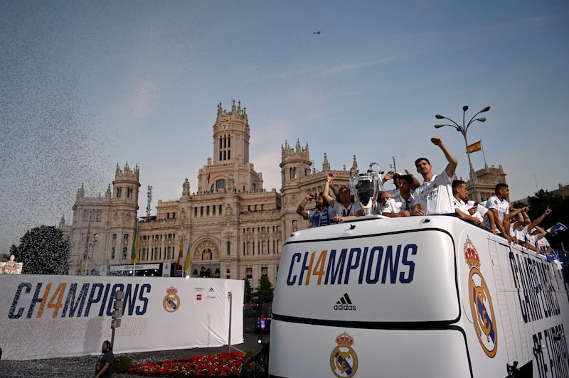Real Madrid players wave from an open-top bus at the Cibeles square in Madrid. AFP