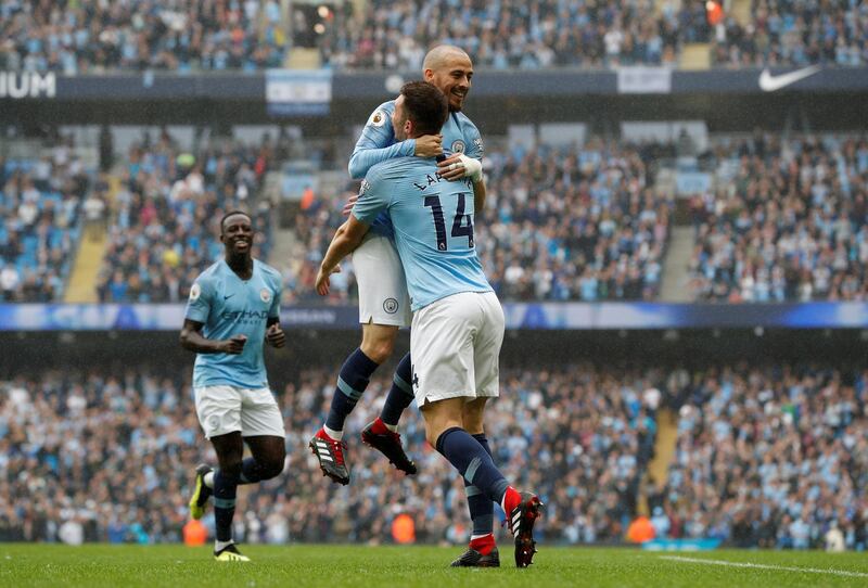 Manchester City's David Silva celebrates scoring their fourth goal with Aymeric Laporte. Reuters