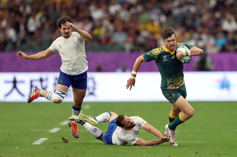 Adam Ashley-Cooper of Australia avoids Felipe Berchesi and Rodrigo Silva of Uruguay. Getty