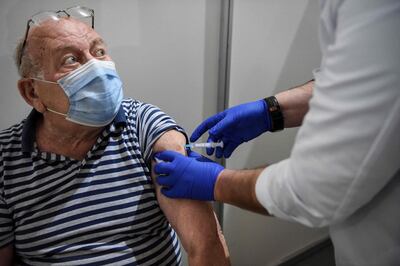 An elderly man receives a dose of the Sputnik V vaccine against the Covid-19 at the Boris Trajkovski sports hall in Skopje as the country start its vaccination campaign, after months of difficulties on April 16, 2021. Moscow announced on April 14, 2021 the start of production of its Sputnik V coronavirus vaccine in Serbia, the first European country outside Russia and Belarus to manufacture the vaccine. / AFP / Robert ATANASOVSKI
