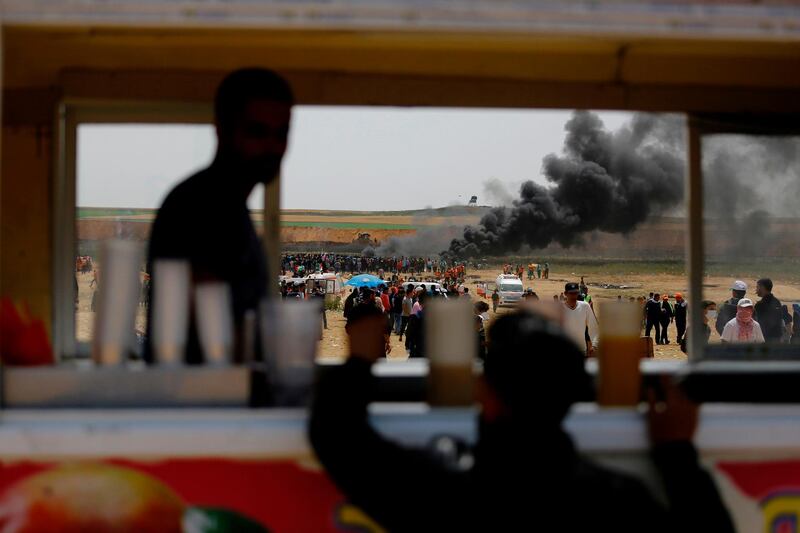 Palestinians protesters burn tires at the border fence with Israel, east of Jabalia in the central Gaza city. Mohammed Abed / AFP Photo