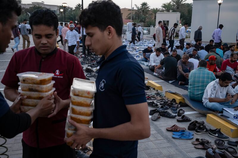 Devotees collect their iftar meals at Al Farooq Omar bin Al Khattab Mosque in Dubai. Antonie Robertson / The National