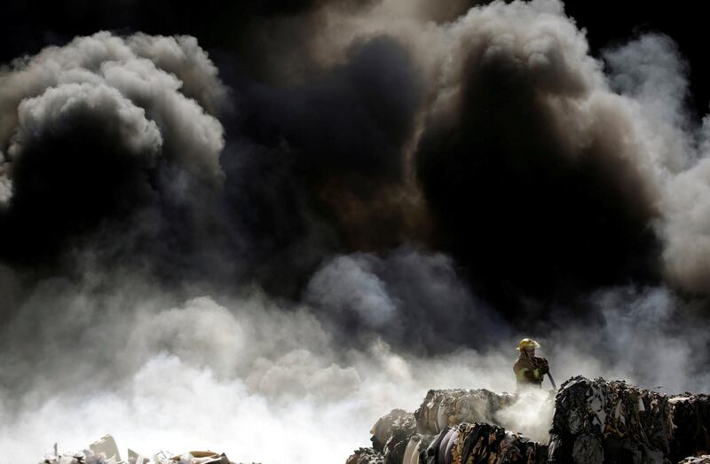 A firefighter puts out a blaze at a recycling centre in Ciudad Juarez, Mexico. Jose Luis Gonzalez / Reuters
