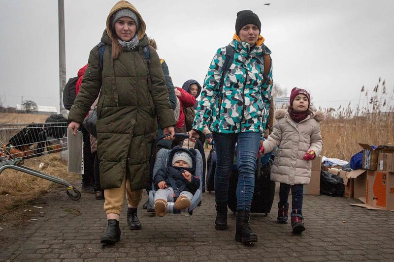 Refugees, mostly women with children, arrive at the border crossing in Medyka, Poland, Saturday, March 5, 2022, after fleeing Russian invasion in Ukraine.  (AP Photo / Visar Kryeziu)
