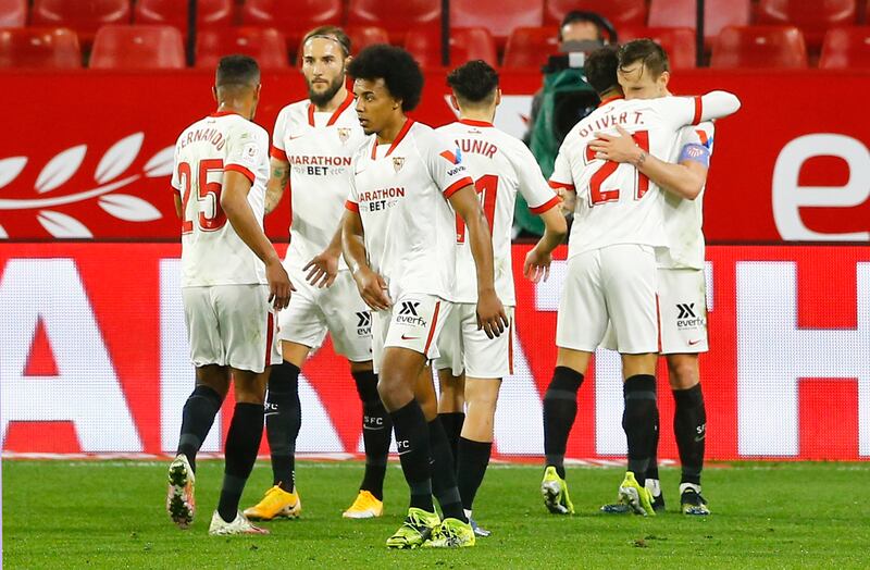 Sevilla's Ivan Rakitic celebrates scoring their second goal with Oliver Torres and teammates. Reuters