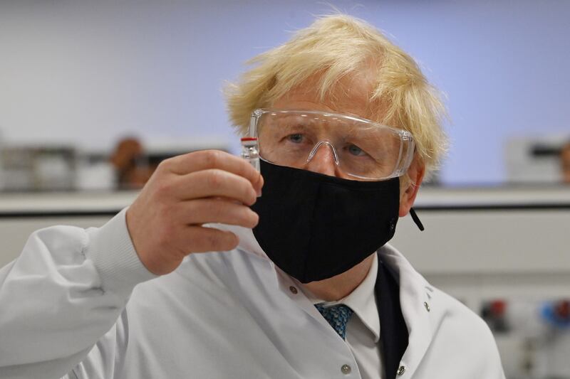 Mr Johnson with a vial of the AstraZeneca Covid-19 candidate vaccine, known as AZD1222, at Wockhardt's pharmaceutical manufacturing facility, in November 2020, in Wrexham, Wales. Getty Images