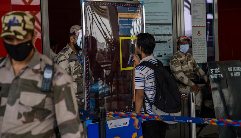 DELHI, INDIA - MAY 26: Indian security personnel check the identity card of a man before allowing him in the Terminal 3 at the Indira Gandhi International Airport, as the country relaxed its lockdown restriction on May 26, 2020 in Delhi, India. With a slew of guidelines for passengers, India allowed commercial domestic flights to resume operations on May 25  for the first time since imposing a nationwide lockdown on March 25 to curb the spread of coronavirus which has claimed over 4,000 lives in India so far. (Photo by Yawar Nazir/Getty Images)