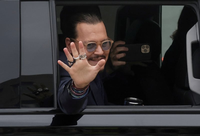 Depp waves goodbye to fans. Reuters